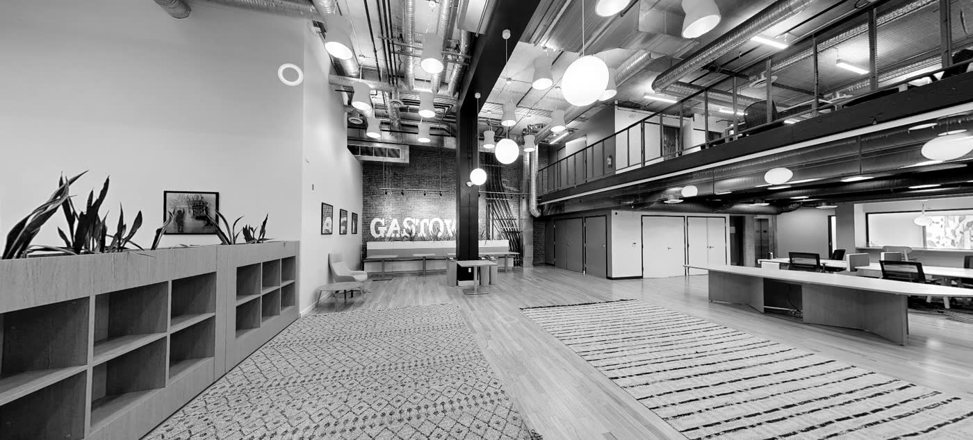 Heritage floor in Gastown with exposed slab, spiral ducts, brick and a mezzanine